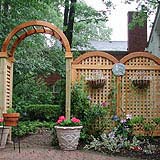 wood garden arbor with arched square lattice vine trellis by elyria fence